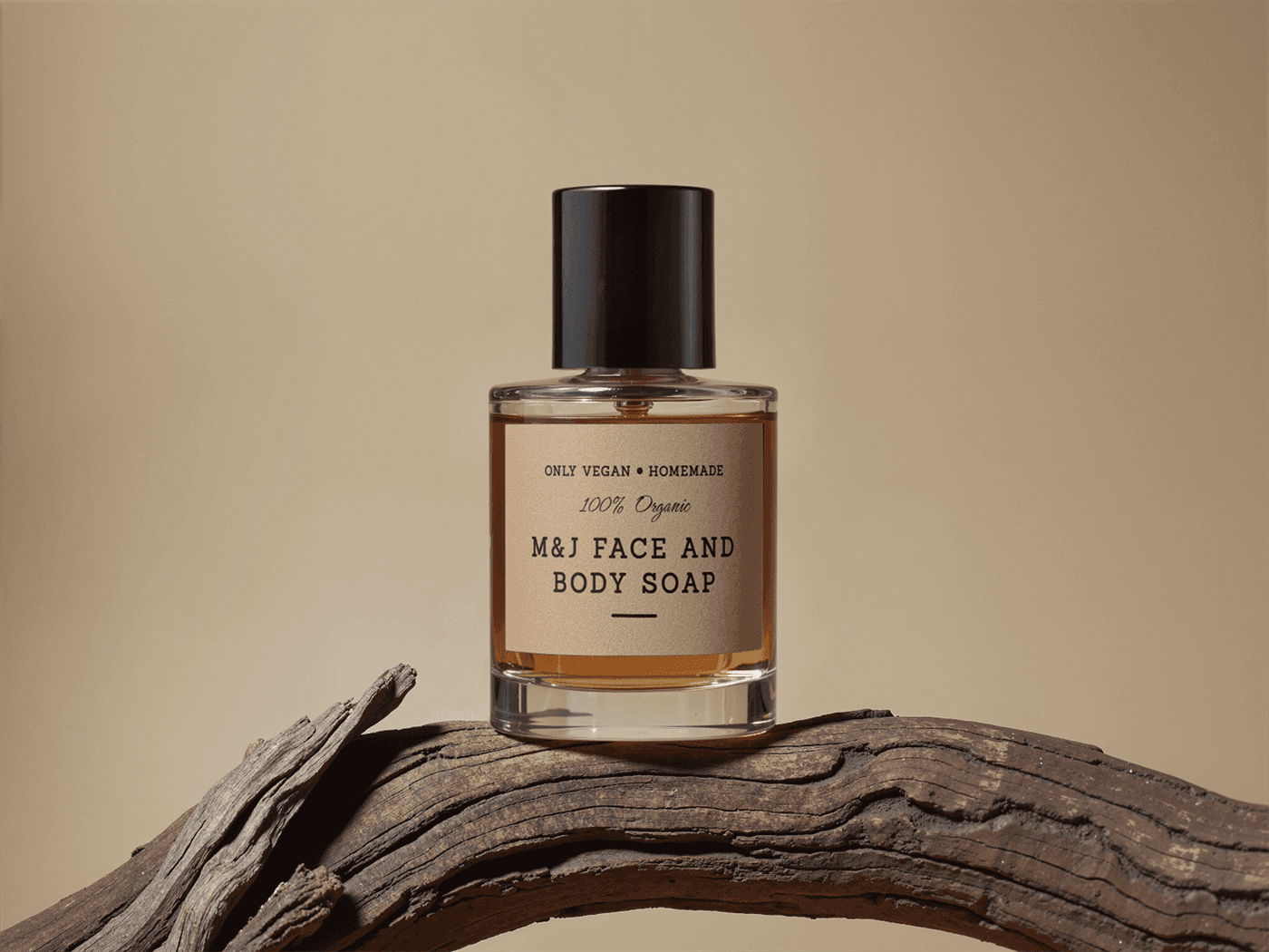 M&J face and body soap bottle photographed on driftwood